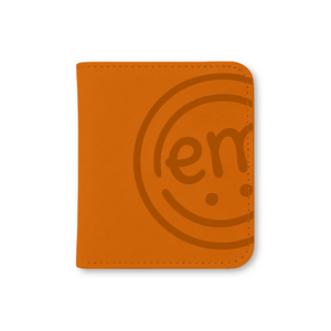 An orange-colored storage case designed like a photo book to keep all your ExpressionMed sensor patches organized and easy to find.