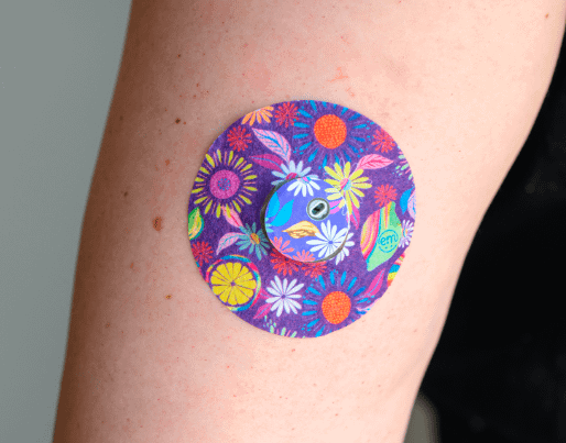 ExpressionMed, Purple Flowers Libre 3 Transmitter Sticker, Sticker and Tape, Human Arm Wearing Purple Flowers Designed CGM Adhesive Patch Design