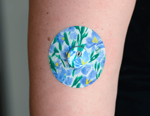 ExpressionMed, Hyacinths Libre 3 Transmitter Sticker, Single Sticker and Single Tape, Human Arm Wearing Hyacinths Designed CGM Adhesive Patch Design