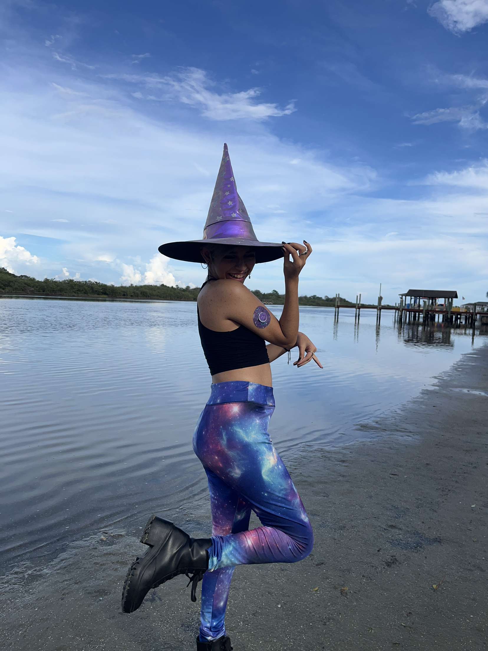 Woman in witch outfit on the beach with Witchy Libre Tape and Transmitter Sticker on her arm, Abbott Lingo