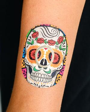 ExpressionMed, Dia de los Muertos Dexcom G7 and Stelo Tape, Human Wearing Dia de los Muertos Themed CGM Adhesive Patch Design.