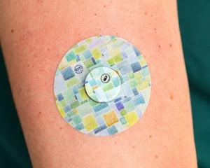 ExpressionMed, Watercolor Geometrics Libre 3 Transmitter Sticker, Tape & Sticker, Human Wearing Watercolor Geometrics Themed CGM Adhesive Patch Design