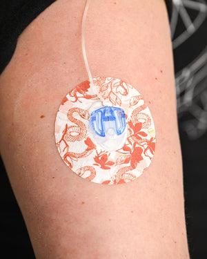 ExpressionMed, Lava Coil Floral Infusion Set Tape, Sticker Only, Arm Wearing Lava Themed CGM Adhesive Patch Design