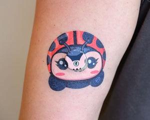 ExpressionMed, Lady Bug Libre 3 Transmitter Sticker, Tape & Sticker, Human Wearing Lady Bug Themed CGM Adhesive Patch Design