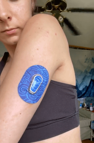 ExpressionMed Woman with Watercolor Waves Dexcom G6 Mini Tape and Transmitter Sticker on arm