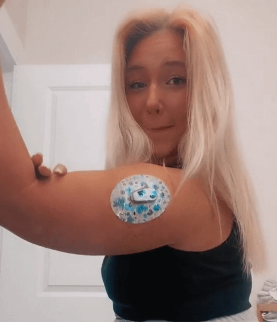 Woman with Sapphire Petals Dexcom G6 Tape and Transmitter Sticker on arm