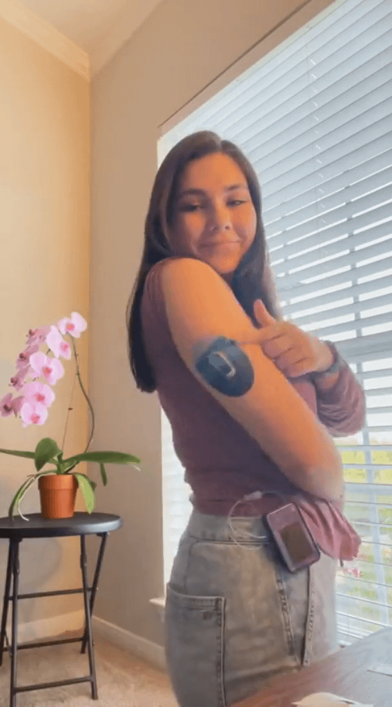 Woman with Watercolor Skies Dexcom G6 Tape and Transmitter Sticker on arm