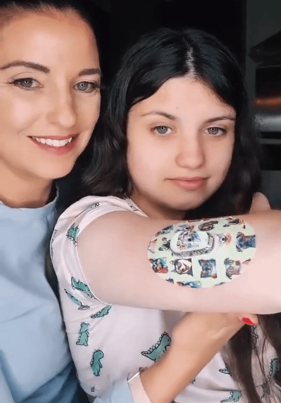 ExpressionMed Woman and daughter with dog party dexcom G6 tape and transmitter sticker on arm