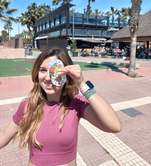 ExpressionMed Woman outdoors holding Flowering Amethyst Libre Tape and other tapes in front of eye