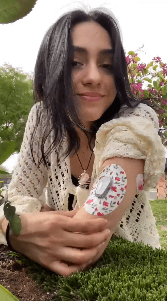 ExpressionMed Woman outside with Rose Garden Dexcom G6 Tape on arm