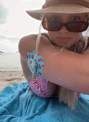 Woman at beach with Watermelon Slice Pod Tape and sticker on arm