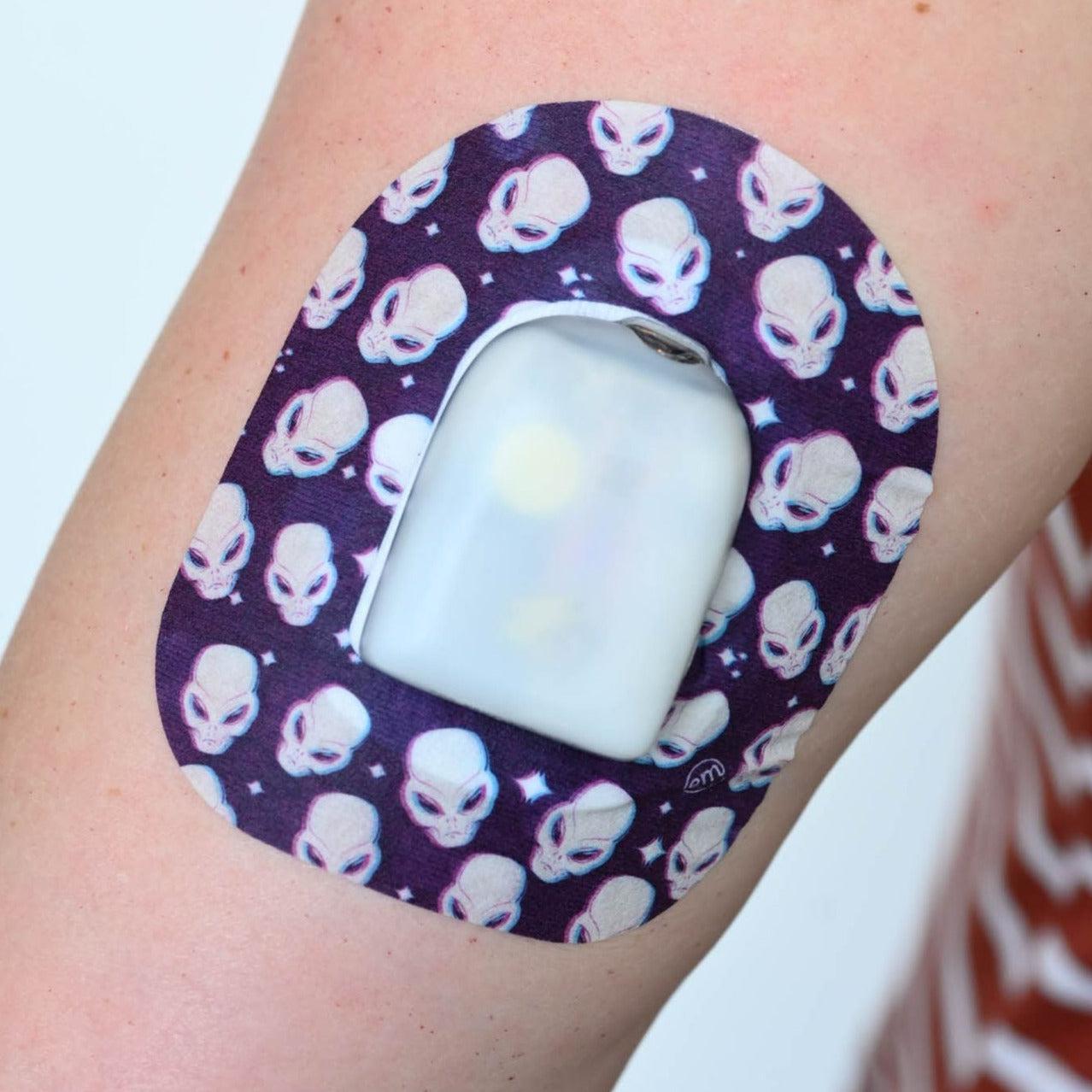 Human arm wearing Alien Pod Patch Design and Omnipod Device