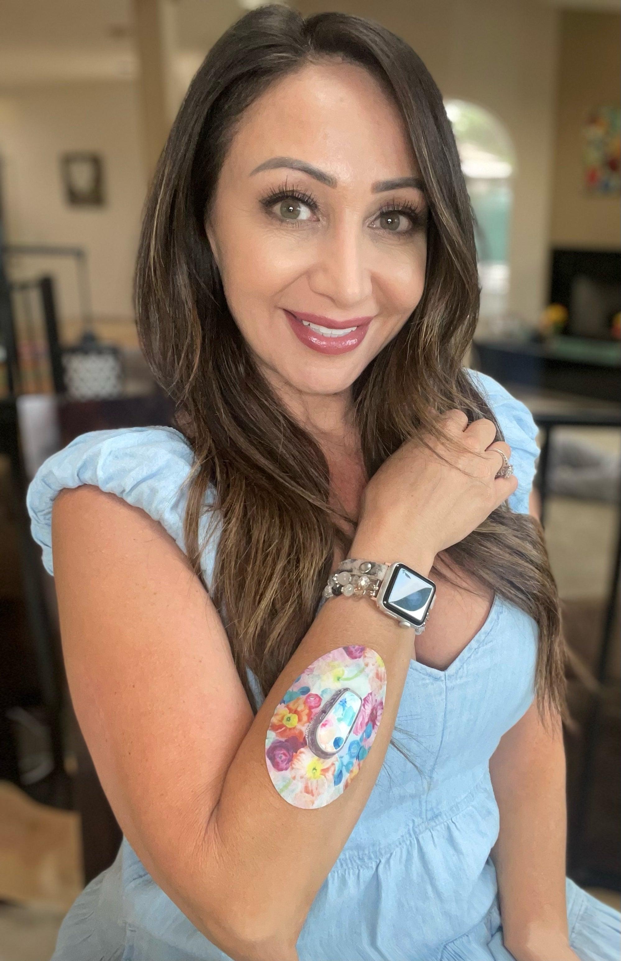 Woman with Watercolor Poppies Dexcom G6 Tape and Transmitter Sticker on arm
